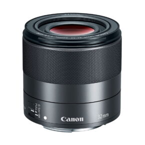 Canon_EF-M_32mm_f_1_4_STM_001 The Canon EF-M 32mm f/1.4 STM lens, which is black and metallic with focus and AF/MF switches, is shown against a white background.