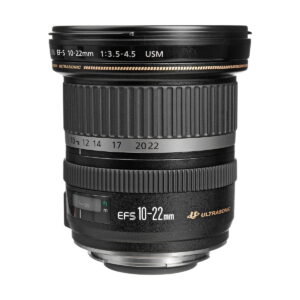 Canon_EF-S_10-22mm_f_3_5-4_5_USM_002 The Canon EF-S 10-22mm f/3.5-4.5 USM lens stands upright against a white background, with its focus rings, zoom rings, gold accents and lens details visible.