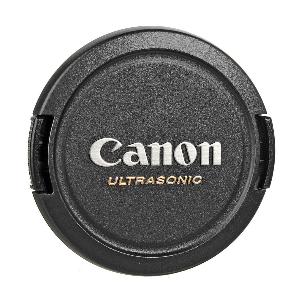 Canon_EF-S_10-22mm_f_3_5-4_5_USM_004 The photo shows a lens cover with a black textured surface and attachable side grips for the Canon EF-S 10-22mm f/3.5-4.5 USM lens, against a white background.