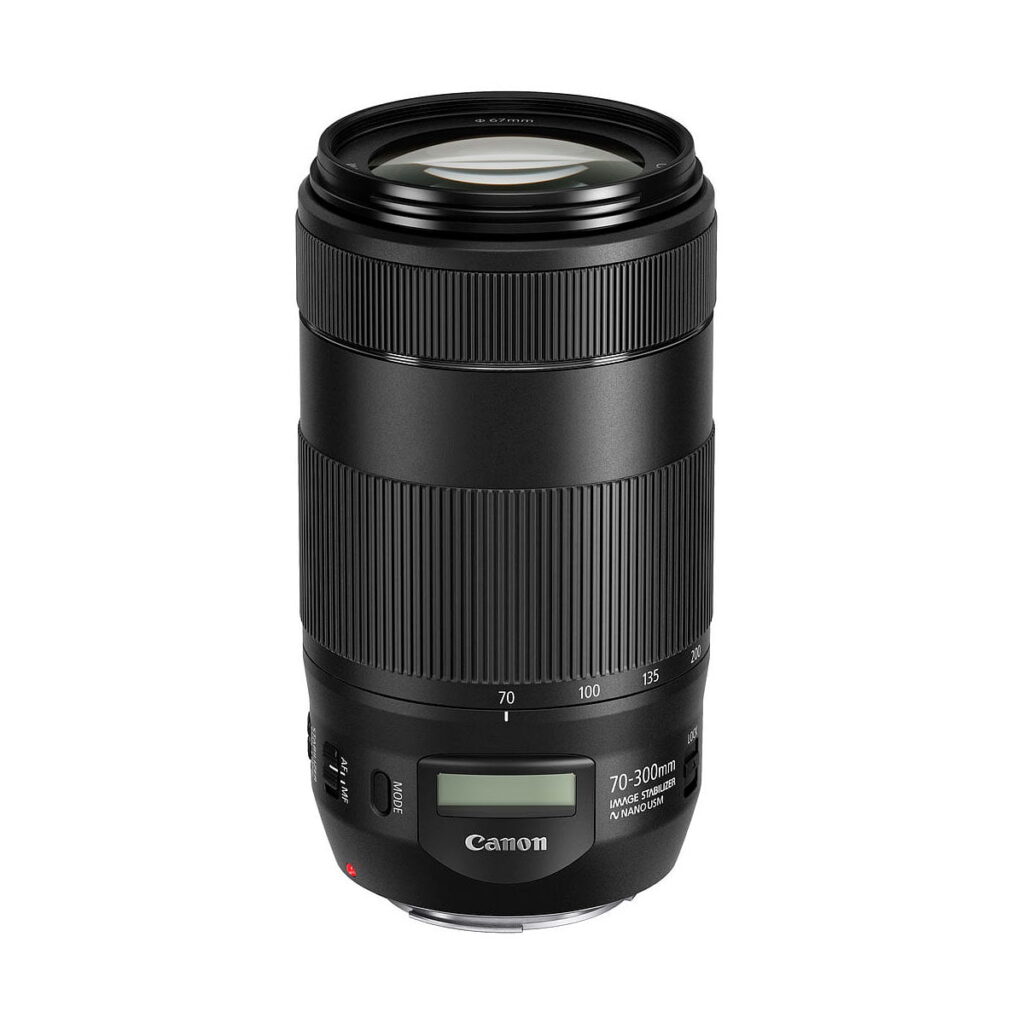 Canon_EF_70-300mm_f_4-5_6_IS_II_USM_001 The Canon EF 70-300mm f/4-5.6 IS II USM lens, in black with a textured grip, LCD screen and focus and zoom indicators, stands upright against a white background.