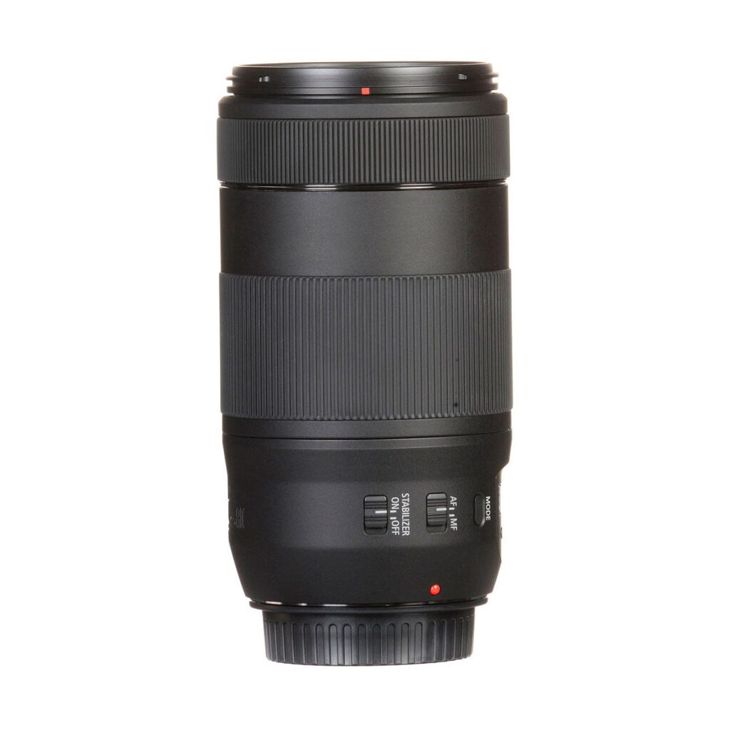 Canon_EF_70-300mm_f_4-5_6_IS_II_USM_004 The Canon EF 70-300mm f/4-5.6 IS II USM is a black camera zoom lens with textured grip rings and control dials, shown upright on a white background.