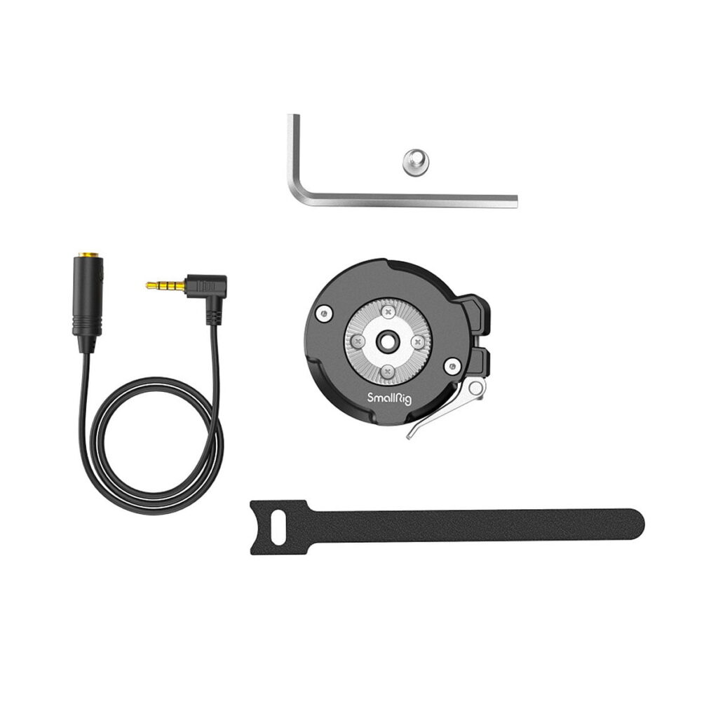 SmallRig_Handgrip_Rosette_Adapter_for_Sony_FX6_3403_002 The SmallRig 3403 Handgrip Rosette adapter for Sony FX6 is pictured with a 3.5mm audio cable, a round black cable holder, a black mounting strap and part of a metal frame at the top.
