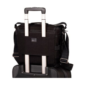 Think_Tank_Retrospective_10_V2_0-Musta_004 The Think Tank Retrospective 10 V2.0 - Black appears securely attached to the extended handle of a roll-on suitcase and shows how it fits over the suitcase handle for convenient travel.
