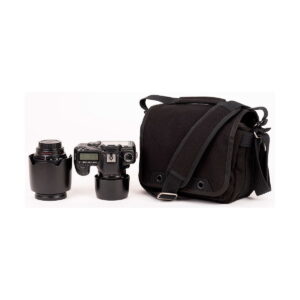 Think_Tank_Retrospective_5_V2_0-Musta_004 Think Tank Retrospective 5 V2.0 - The black camera bag is pictured next to the digital camera with the lens attached and an extra lens with the cover up, all placed on a plain white background.
