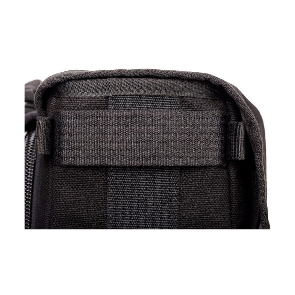Think_Tank_Retrospective_Backpack_15-Black_004 Close-up Think Tank Retrospective Backpack 15, black with accented horizontal strap and zipper. Stitching and textured black nylon material emphasise the durability of the backpack.