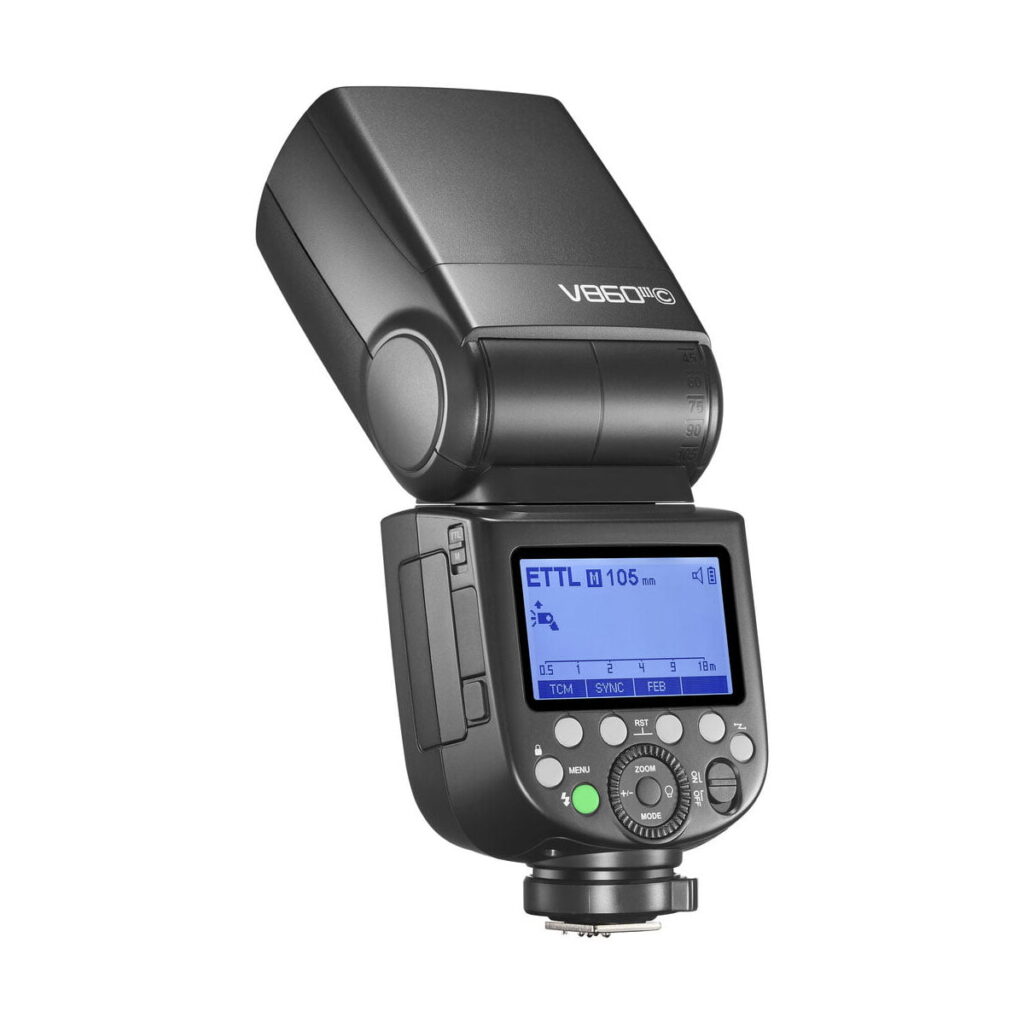 Godox-Ving-V860-III-TTL---Canon-2 Mustassa Godox Ving V860 III TTL -salama Canon kameroille on digitaalinen näyttö, säätöpainikkeet ja kääntyvä pää, kuvattuna valkoisella taustalla.