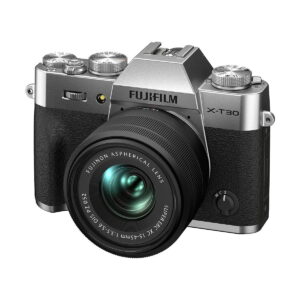 Fujifilm_X-T30_II__Hopea_006 Hopeamusta ja hopeanvärinen Fujifilm X-T30 II Hopea -peilitön digitaalikamera, johon on kiinnitetty Fujinon-asfäärinen objektiivi, hieman vinossa valkoisella taustalla.