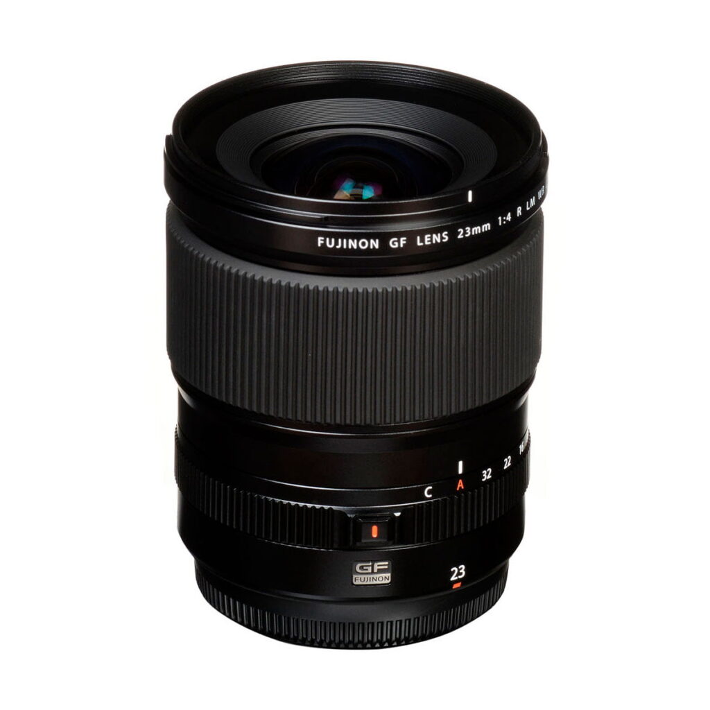 Fujinon_GF_23mm_f_4_R_WR_003 The Fujifilm Fujino GF 23mm f/4 R LM WR lens stands upright on a white background, with its focus and aperture rings clearly marked with stickers and labels.