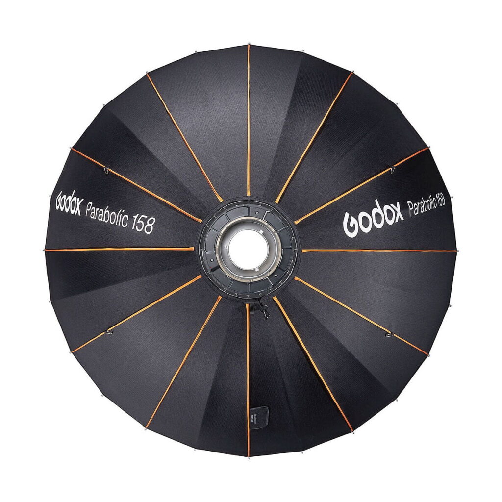 Godox_Parabolic_158_Reflector_Kit_003 The black Godox Parabolic 158 reflector set features orange brackets on the top, a circular metal bracket in the middle and the brand and model printed in white on the fabric.