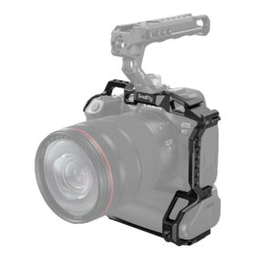 SmallRig_Camera_Cage_for_EOS_R5_R6_with_BG-R10_Battery_Grip_3464_001 Canon EOS R5 objektiivin kanssa on asennettu mustan SmallRig 3464 Camera Cage for EOS R5/R6 with BG-R10 Battery Grip -kamerahäkin sisään, jossa on yläkahva ja useita kiinnityspisteitä. Häkki ja kahva näkyvät selvästi; kamera on osittain läpinäkyvä.