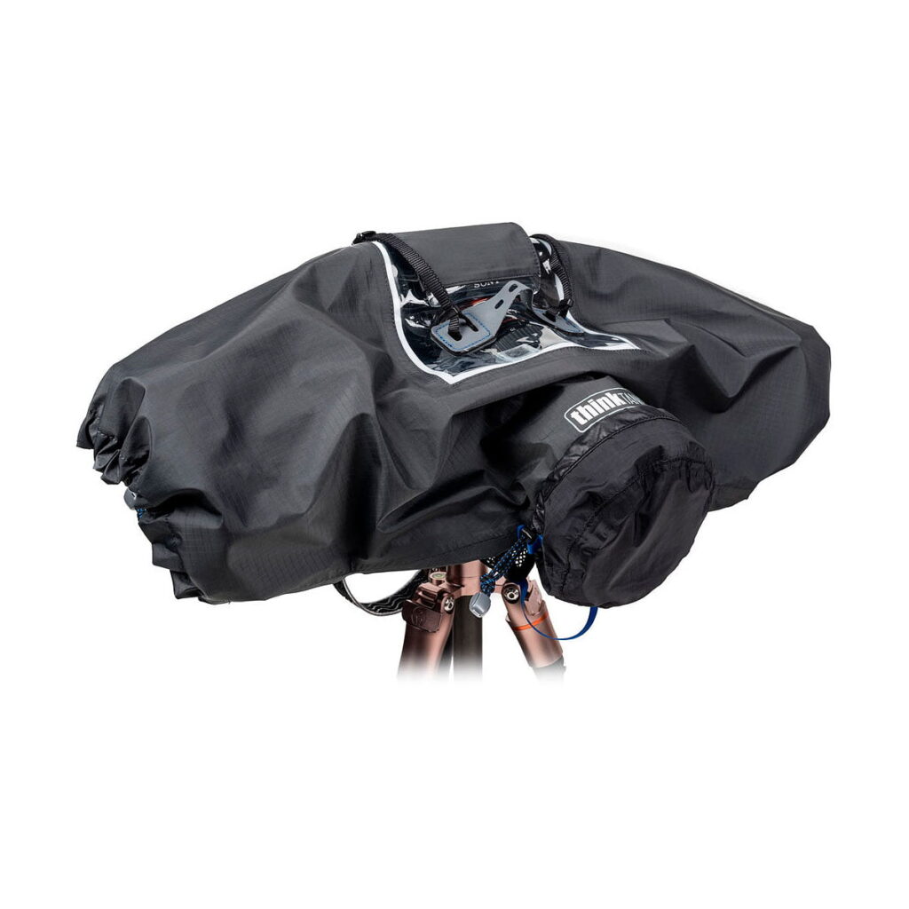 Think_Tank_Photo_Hydrophobia_D_24-70_V3_001 The Think Tank Hydrophobia D 24-70 V3 is a black waterproof camera rain cover with a clear window, designed to fit over your camera and tripod and protect your gear from rain and harsh weather.