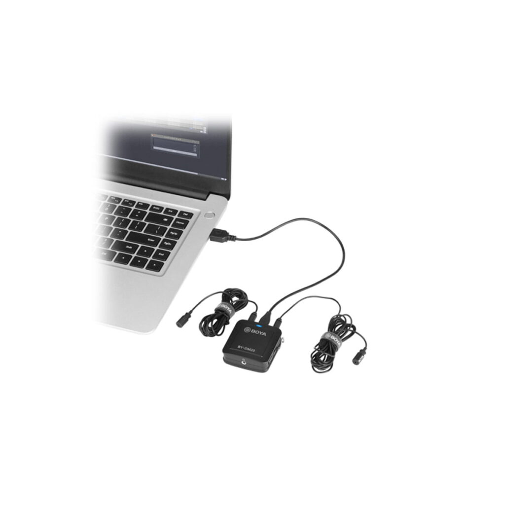 Boya-BY-DM20-4 Musta Boya BY-DM20 Dual Lavalier mikrofoni USB-ääniliitäntä on liitetty hopeiseen kannettavaan tietokoneeseen. Liitäntään on kytketty kaksi langallista lavalier-mikrofonia, joiden kaapelit on kierretty siististi lähelle. Tausta on valkoinen.