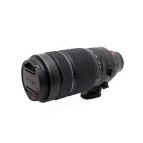 Black Olympus OM-D E-M1X (SC 460) - A used camera with zoom and focus rings and tripod mount collar is shown on a white background.