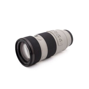 Sony FE 70-200mm f/4 OSS (Kunto K4.5) - Käytetty, teleobjektiivi, jossa on musta kahva, useita säätökytkimiä ja vaaleanharmaa tynnyri, näkyy valkoisella pohjalla.