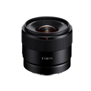 Sony-E-11mm-f1.8 A Sony E 11mm f/1.8 lens, a black camera lens with a wide grooved focusing ring and white E 1.8/11 text, shown on a white background.