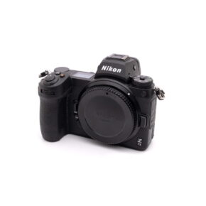 Nikon Z7 II (SC 8500, Warranty 12 months) - Used mirrorless camera body in black with white background, slightly tilted to the right, with lens cover and without lens.