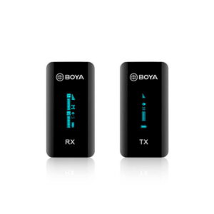 Two black Boya BY-XM6-S1 microphone system units with small digital displays, labelled RX (receiver) on the left and TX (transmitter) on the right, are visible against a white background.