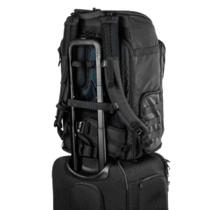 Tenba-Axis-V2-32L-4 The Tenba Axis V2 32L Backpack in black, with padded straps and multiple compartments, is attached to a suitcase handle that showcases its sleek, travel-friendly design.