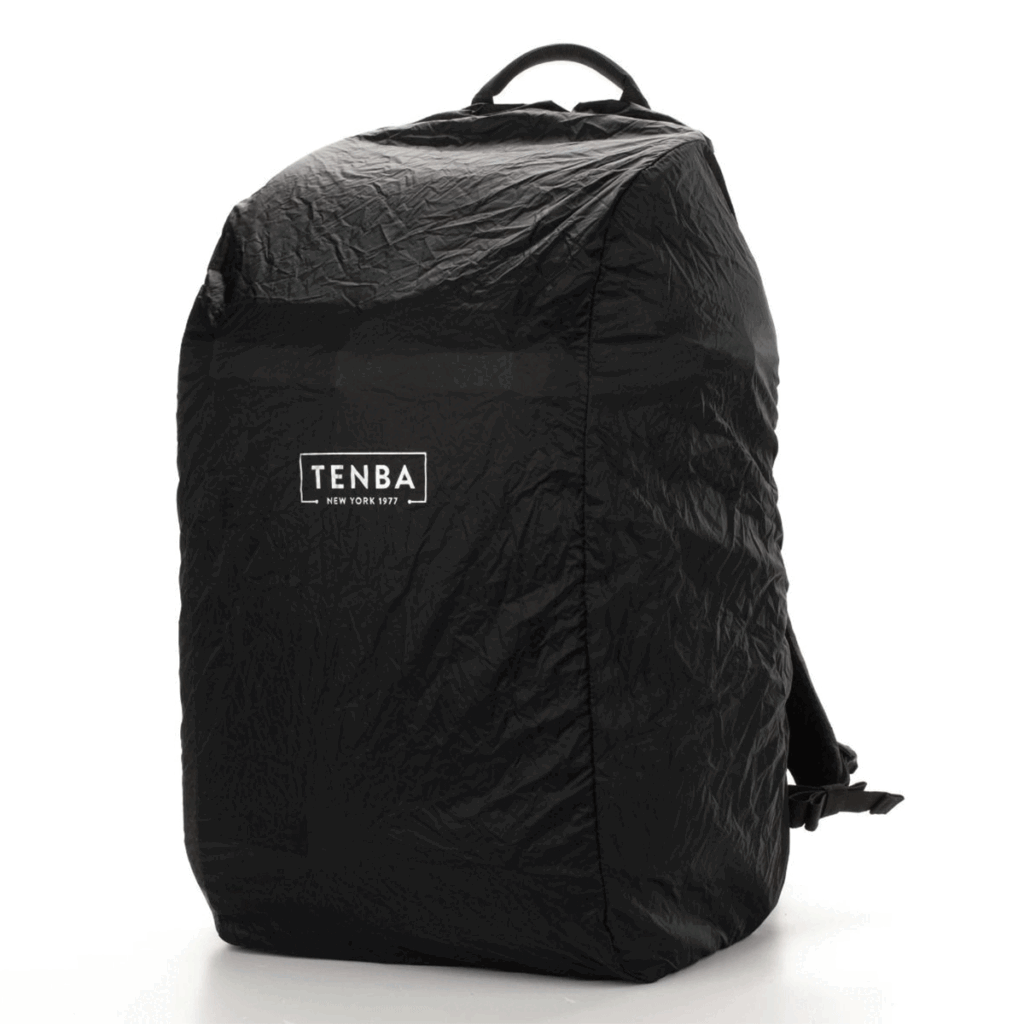 Tenba-Axis-V2-32L-8 The Tenba Axis V2 32L Backpack is a black, weatherproof backpack with a crinkled lid and a white Tenba logo on the front, which appears upright against a white background.