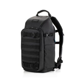 Tenba-axis-V2-16L Tenba Axis V2 16L Backpack -kamerareppu on musta taktisen tyylin reppu, jossa on useita ulkoisia hihnoja, solkia ja pehmustetut olkahihnat, kuvassa pystyasennossa valkoisella pohjalla.
