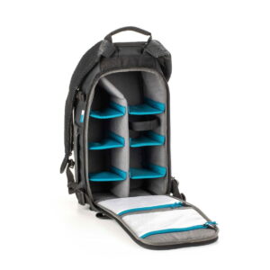 Tenba-axis V2-16L-3 The Tenba Axis V2 16L backpack is shown open to reveal several padded, adjustable compartments with blue dividers for organizing gear and two zippered mesh pockets inside the front flap.
