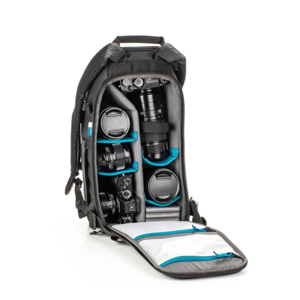 Tenba-axis V2-16L-4 The Tenba Axis V2 16L Camera Backpack opens to reveal neatly organized cameras and lenses in padded compartments, while the lid features zippered mesh pockets for organized storage of camera gear.