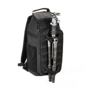 Tenba-axis V2-16L-5 The Tenba Axis V2 16L Backpack is a black camera backpack with multiple zippered compartments, a top handle and a silver stand that is attached vertically to the front.