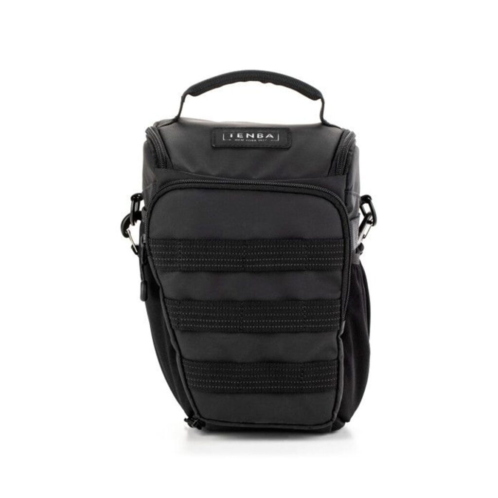 Tenba-axis V2-4L-2 The Tenba Axis V2 4L Top Loader is a compact black camera bag with top handle, zippered front pocket, horizontal stitched details, side clips for shoulder strap and branded label near the top.
