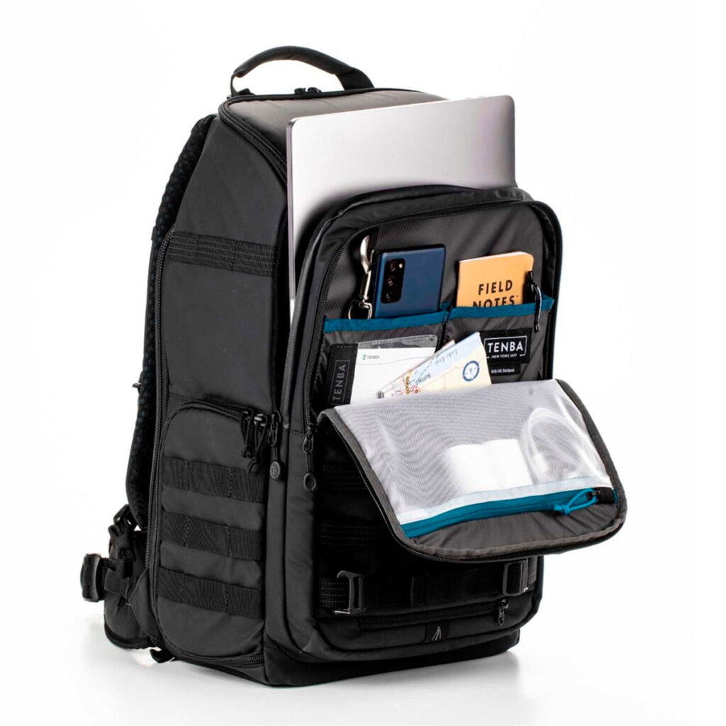 Tenta-axis V2-3 The Tenba Axis V2 24L Camera Backpack is pictured in black with the front pocket open to reveal organised storage space for your laptop, smartphone, pens, notebook, cards and other small items in various compartments and mesh pockets.