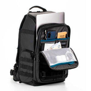 Tenta-axis V2-3 The Tenba Axis V2 24L Camera Backpack is pictured in black with the front pocket open to reveal organised storage space for your laptop, smartphone, pens, notebook, cards and other small items in various compartments and mesh pockets.