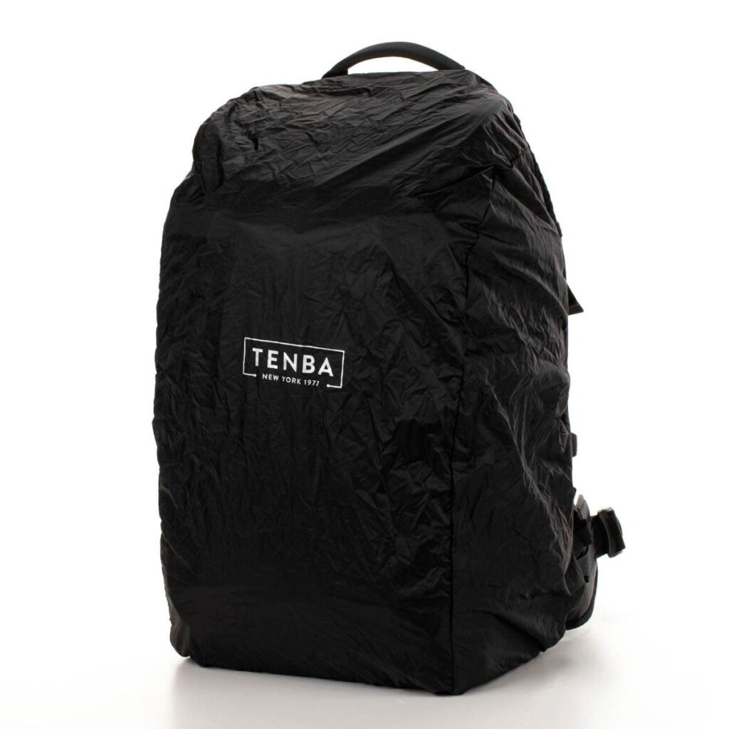Tenta-axis V2-4 The Tenba Axis V2 24L Backpack is a black camera backpack with a wrinkled design and a white TENBA NEW YORK 1977 logo on the front. It stands upright against a plain white background.