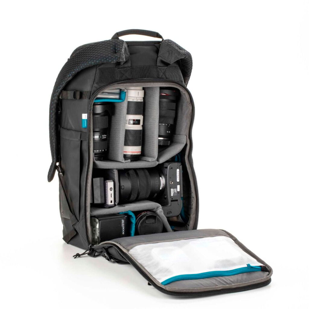 Tenta-axis V2-7 The Tenba Axis V2 24L camera backpack is open to reveal a neatly organised camera equipment - camera bodies, multiple lenses and accessories in padded compartments. The inner lid has a zippered mesh pocket.