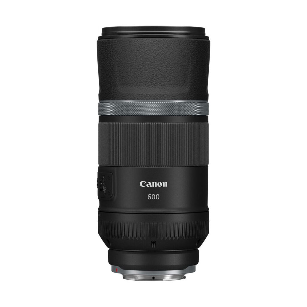 canon_rf_600mm_is_stm_03 The Canon RF 600mm f/11 IS STM lens is shown upright against a white background. The black lens has both textured and smooth parts, and the control switches are visible on the side.