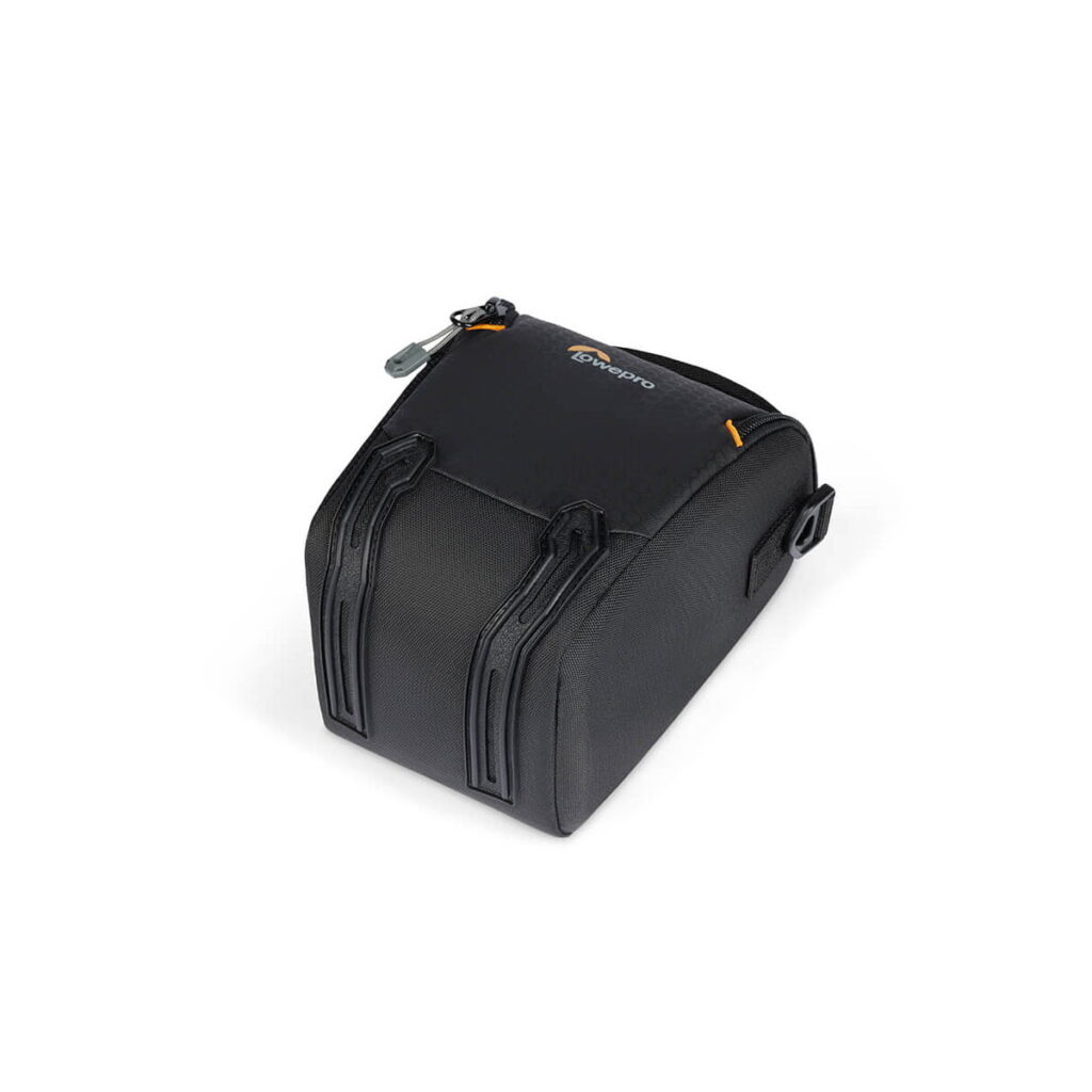 lowepro_tlz_30_iii_01 The Lowepro Adventura TLZ 30 III is a black, compact camera bag with a zippered top, two raised front handles and a small side flap, shown in white.