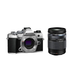 om-5_14-150mm_hopea_01 Hopeinen OM SYSTEM OM-5 -kamera, jossa on 14-150mm f/4-5.6 II -objektiivi, on esillä vaihdettavan zoom-objektiivin kanssa valkoisella taustalla.