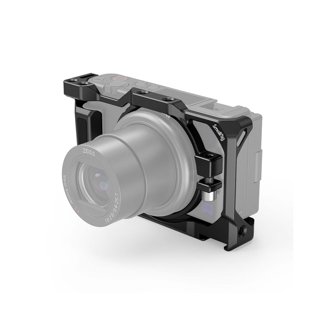 SmallRig_Camera_Cage_for_Sony_ZV-1_2938_001 The SmallRig 2938 camera cage is pictured attached to a Sony ZV-1F / ZV-1 camera on a white background, and offers mounting points and extra durability with its black metal frame.