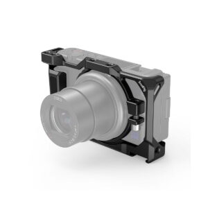 SmallRig_Camera_Cage_for_Sony_ZV-1_2938_001 The SmallRig 2938 camera cage is pictured attached to a Sony ZV-1F / ZV-1 camera on a white background, and offers mounting points and extra durability with its black metal frame.
