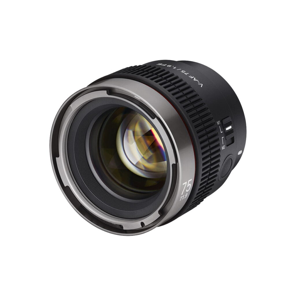 Samyang_V-AF_75mm_T1_9-Sony_FE_004 A close-up of the Samyang V-AF 75mm T1.9 - Sony FE camera lens shows its metal mount, focus and aperture rings and detailed lens markings against a white background.
