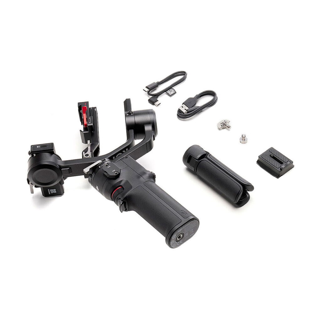 DJi_RS_3_Mini_007 The DJI RS 3 Mini gimbal with handle, detachable tripod, cables, quick release plate and mounting accessories is shown on a white background.