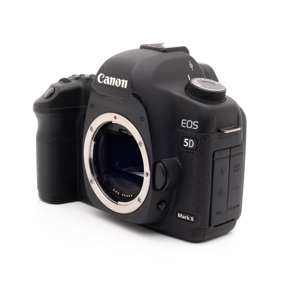Canon 5D Mark II-4 Käytetty Canon EOS 5D Mark II -kamerarunko (SC 20000, sis.ALV24%), musta, ilman objektiivia, näkyy hieman vasemmalle kääntyneenä valkoisella pohjalla.