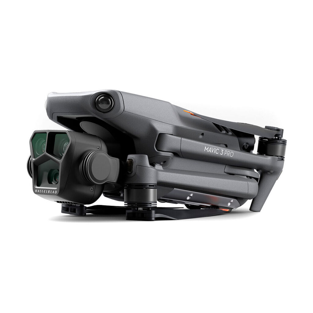 DJI_Mavic_3_Pro_004 Folded DJI Mavic 3 Pro + DJI RC Controller drone with camera and propeller arms visible, shot from a low angle from the front against a white background.