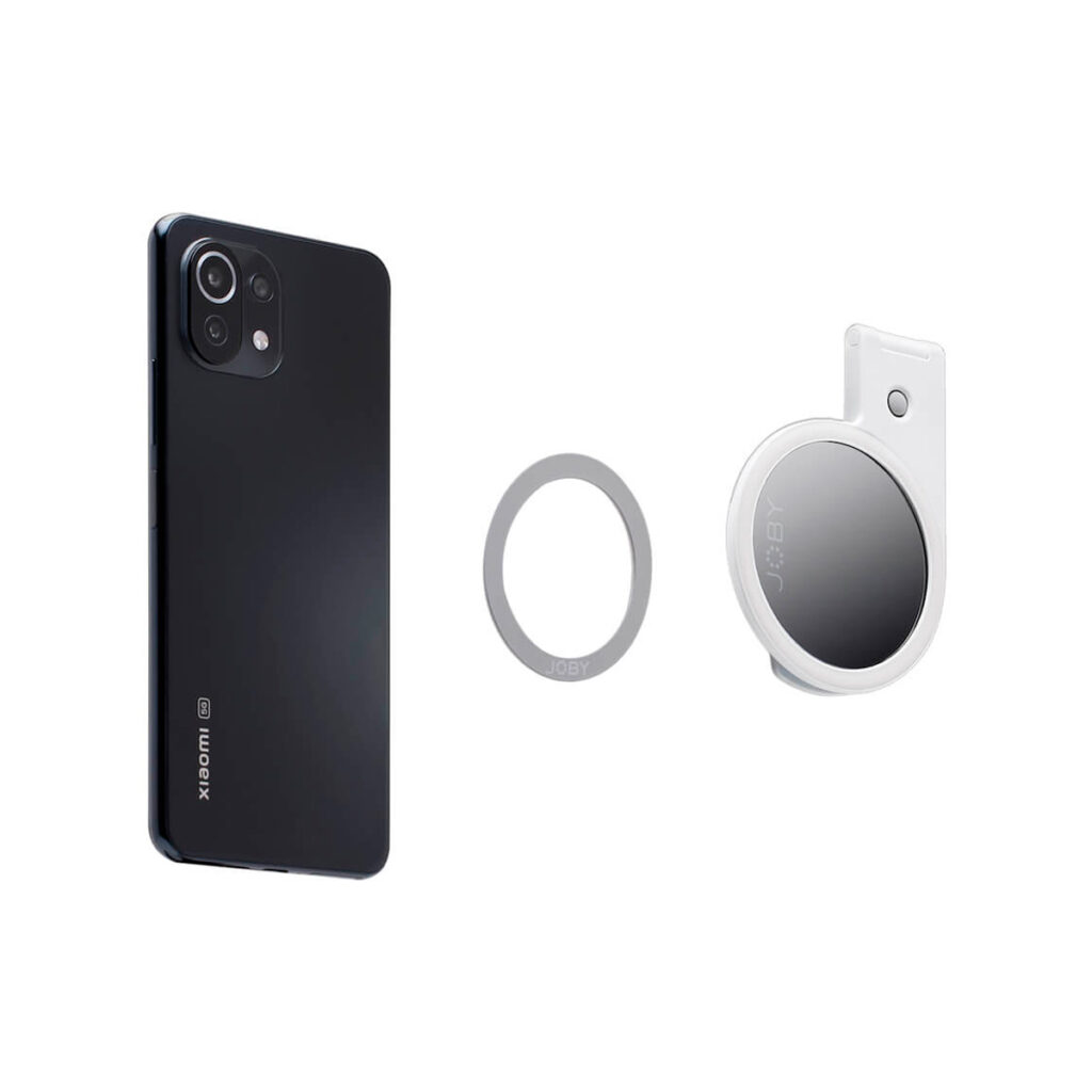 Joby-Beamo-Ring-Light-for-MagSafe-white-5 The white background shows the Joby Beamo Ring Light for MagSafe in white, a black smartphone and a silver ring-shaped accessory.