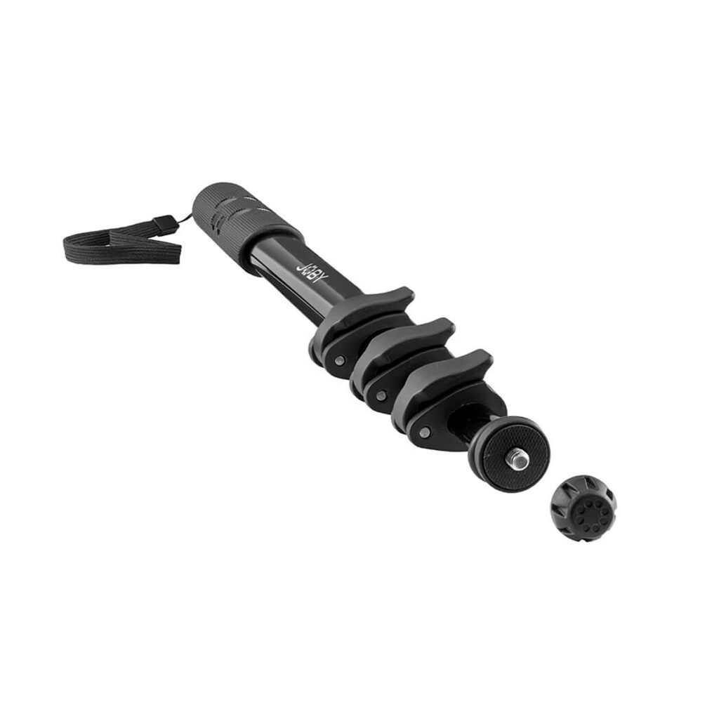 Joby-Compact-2in1-Monopod-3 Mustassa Joby Compact 2in1 Monopodissa on rannehihna, kolme säädettävää lukituskiinnikettä ja irrotettava jalka. Kuvattu valkoisella pohjalla.