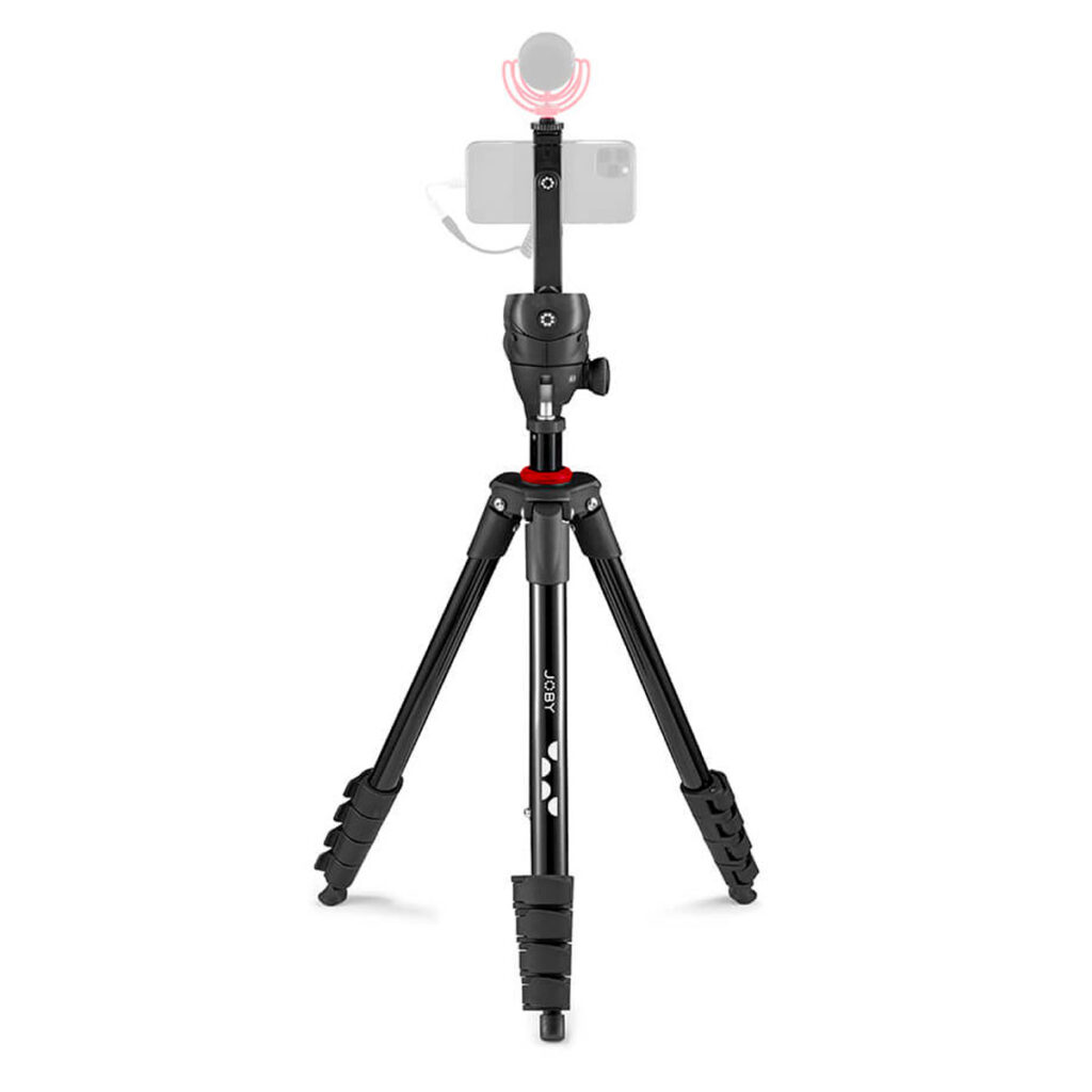 Joby-Compact-Action-3K-Kit-2 The Joby Compact Action 3K Kit, a black stand with red accents and adjustable feet, holds a smartphone and external microphone, ready for recording or streaming on a white background.
