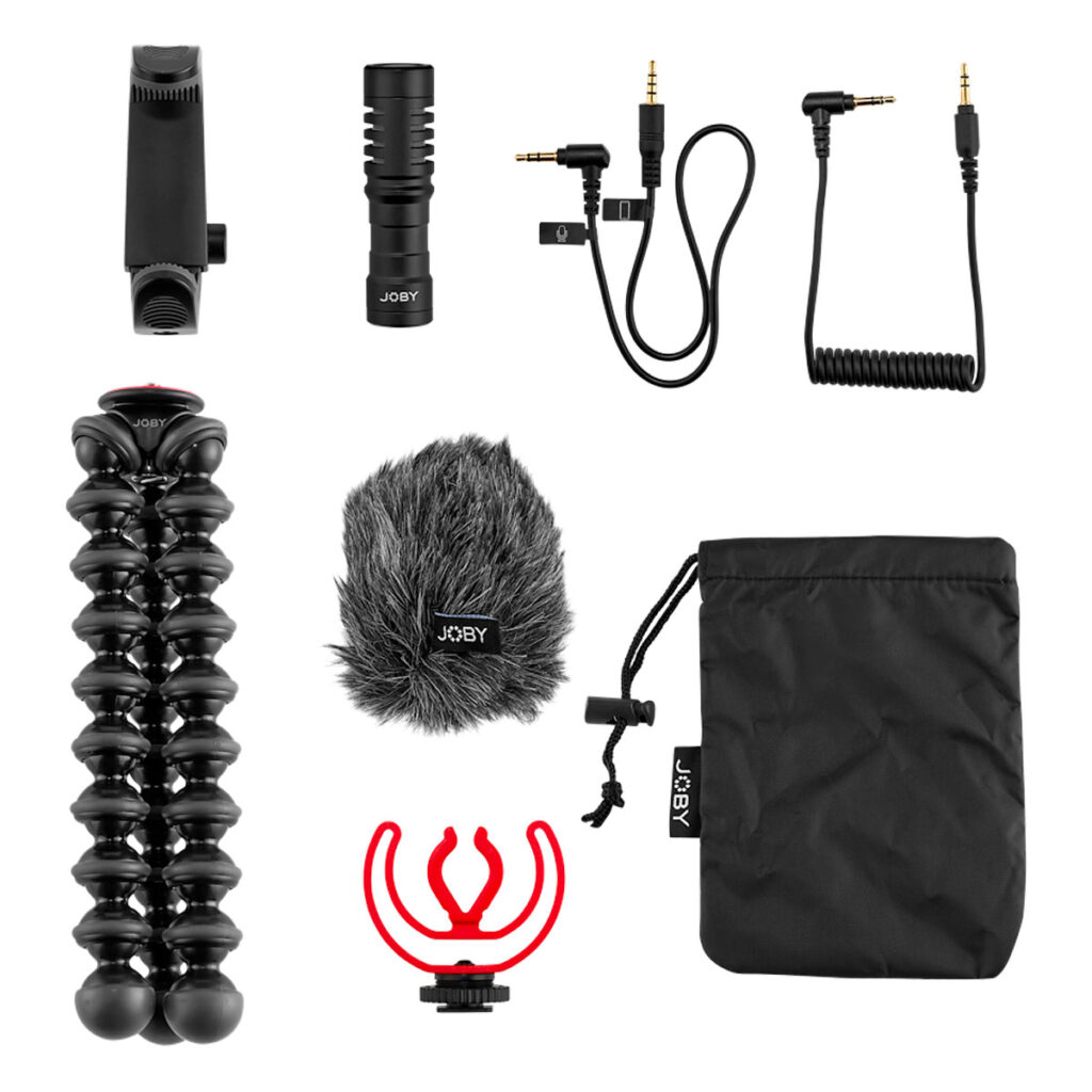 Joby-GorillaPod-Creator-Kit-2 Joby GorillaPod Creator Kitin litteä ulkoasu, jossa on joustava jalusta, haulikkomikrofoni, puhelimen kiinnike, karvainen tuulisuoja, äänikaapelit, punainen sokkikiinnike ja musta kiristysnauhapussi valkoisella pohjalla.