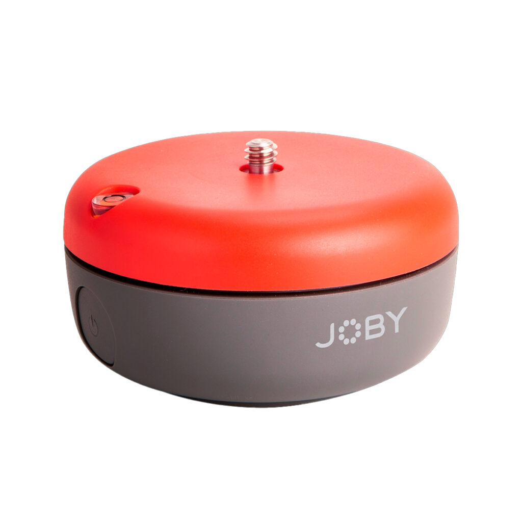 Joby-Spin Joby Spin - Jalustapää on pieni, pyöreä laite, jossa on punainen yläosa, harmaa pohja, metallinen ruuvi yläosassa ja JOBY-logo sivulla.