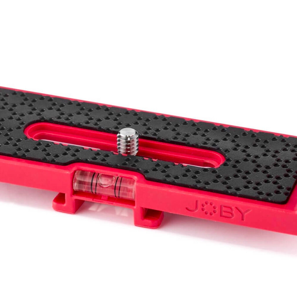 Joby-Vert-Vertical-L-Bracket-4 A close-up view of the Joby Vert Vertical L Bracket shows its red quick release plate, textured black surface, metal screw, bubble level and visible JOBY logo.