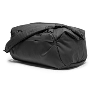 Peak-Design-Travel-Duffel-35l-black-4 Peak Design Travel Duffel 35L - Black on tilava duffel-laukku, jossa on olkahihna ja useita vetoketjullisia lokeroita ja joka on esillä valkoisella pohjalla.