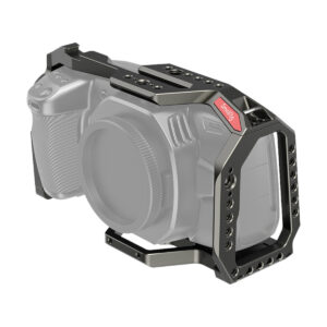SmallRig-2766 Tummanoliivinvärisessä SmallRig 2766 Full Cage for BMPCC 4K & 6K -kamerahäkissä on useita kierteitettyjä reikiä ja punainen kiristysnuppi, ja se on kuvassa asennettu kameran rungon ympärille lisävarusteiden turvallista kiinnitystä ja parempaa tukea varten.