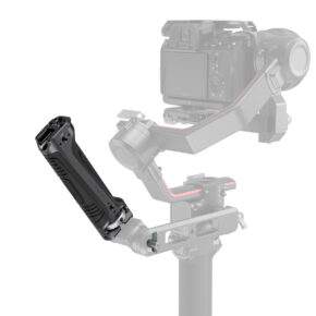 SmallRig-3161 Close-up of the SmallRig 3161 Sling Handgrip for DJI RS 2 / RSC 2 attached to the camera's gimbal, with the black ergonomic grip in focus and the camera and gimbal blurred in the background.